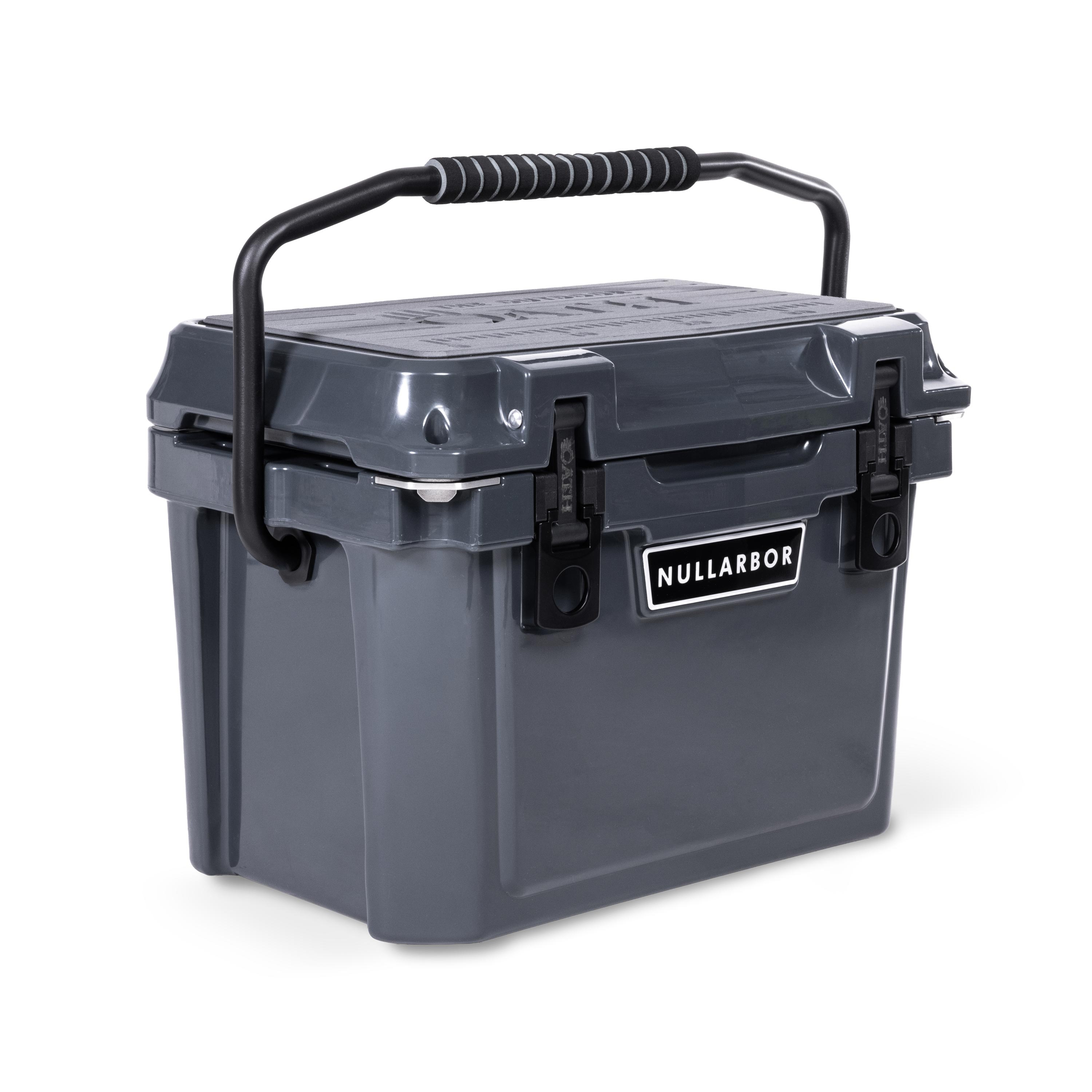 Left side 45 degree view of closed small 19 litre dark grey cooler box with carry handle, 2 easy lock latches on front and bottle openers on each corner. Grey foam mat on lid with fish catch ruler.