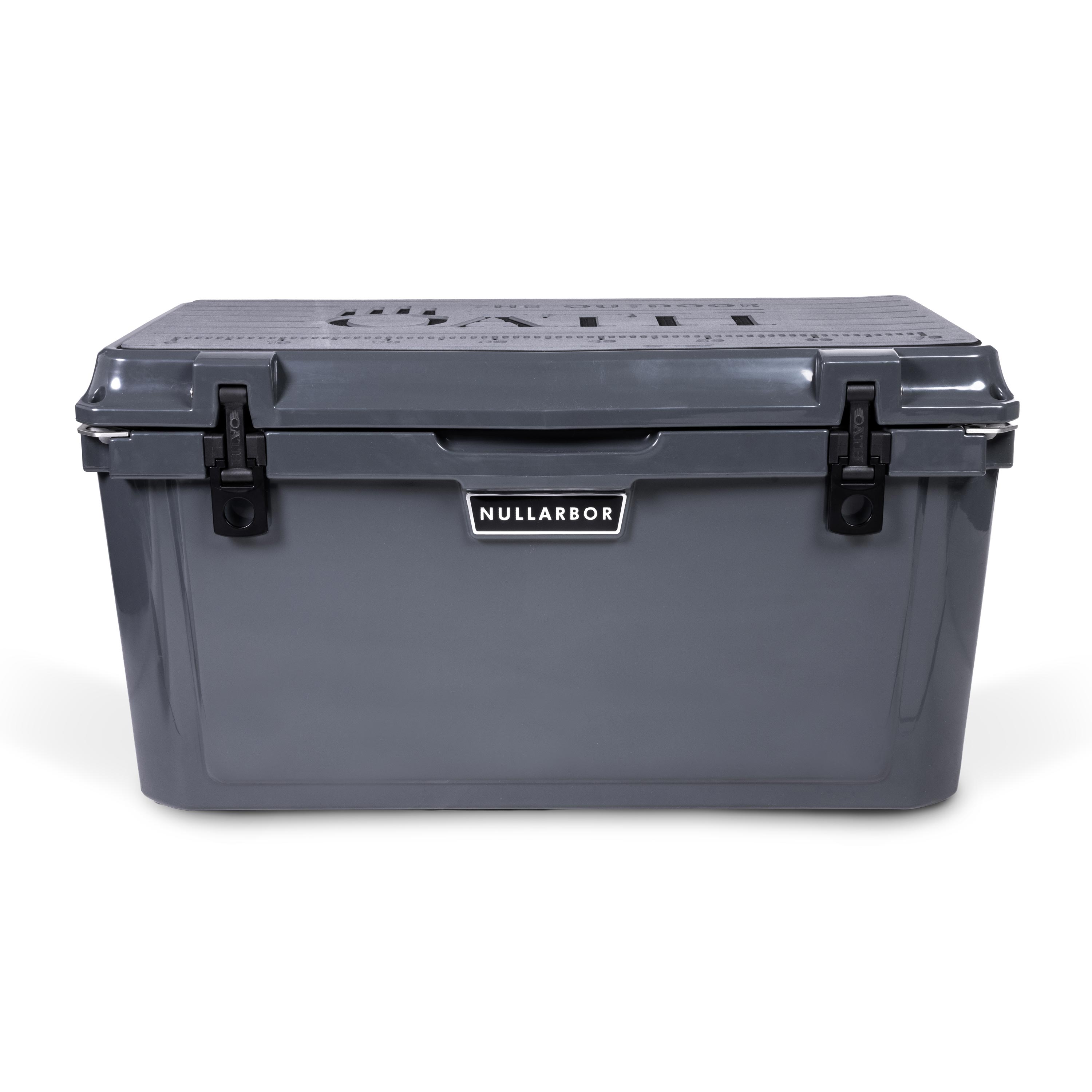 Front view of closed large 71 litre dark grey cooler box with 2 easy lock latches on front and bottle openers on each corner. Grey foam mat on lid with fish catch ruler.