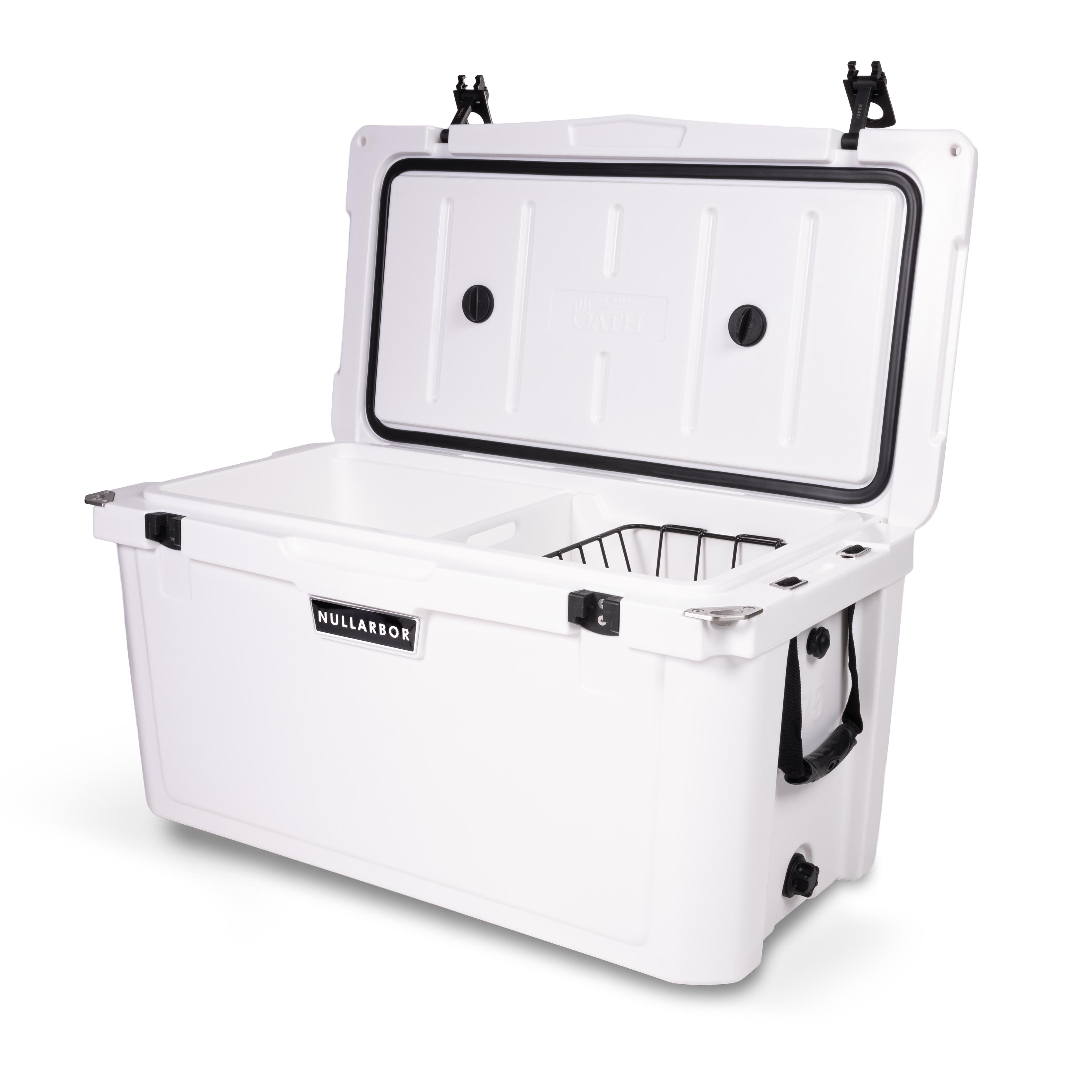 Right side 45 degree view of open large 71 litre white cooler box with side handle, 2 easy lock latches on lid, bottle openers on each corner. Pressure release valve and leak proof easy flow drainage plug on side. Food divider / chopping board and wire food basket inside.