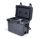 Right side 45 degree view of open small 19 litre dark grey cooler box with side handle, 2 easy lock latches on lid, bottle openers on each corner. Pressure release valve and leak proof easy flow drainage plug on side. Food divider / chopping board and wire food basket inside.