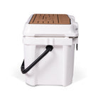 Left side view of closed small 19 litre white cooler box with carry handle. Tan foam mat on lid with fish catch ruler.