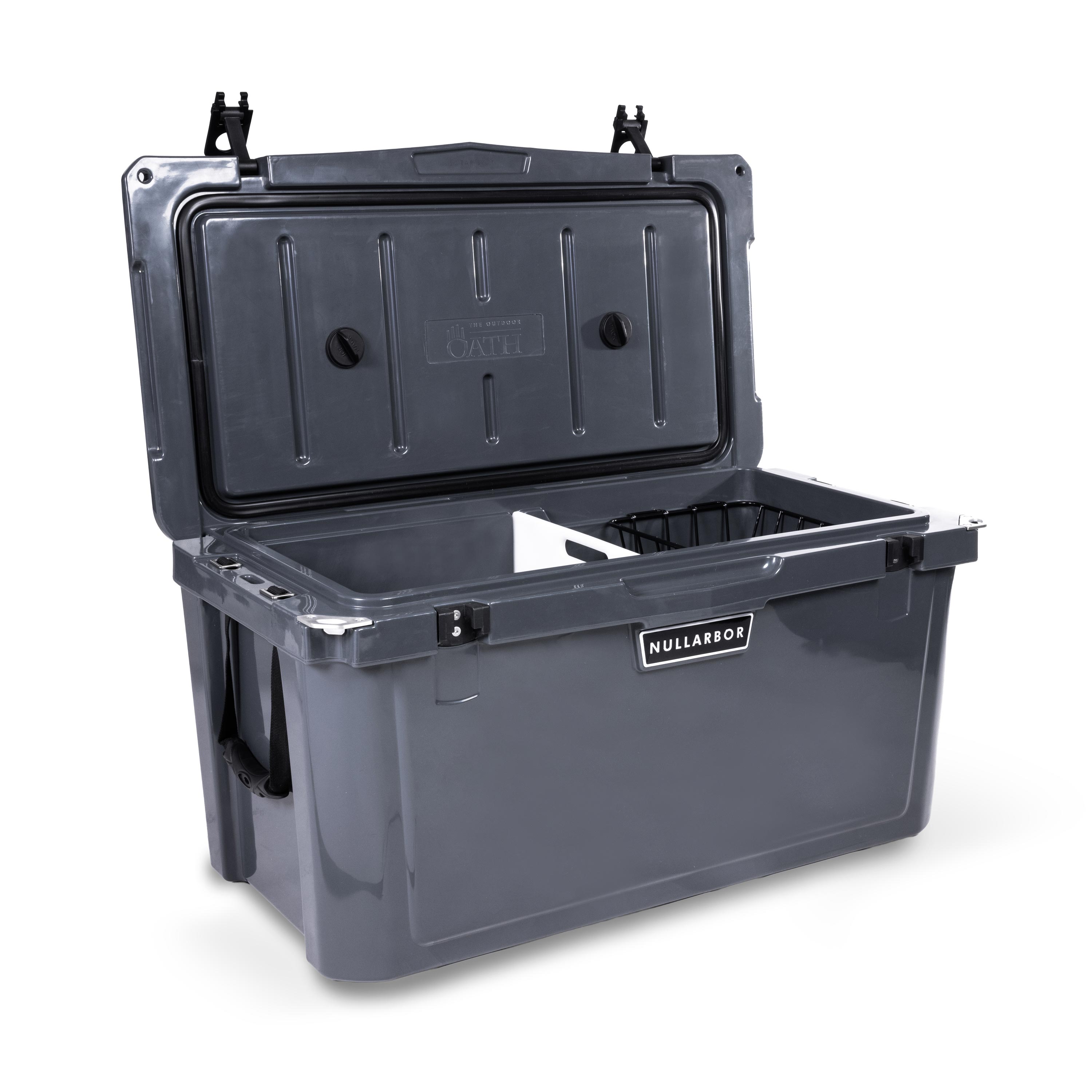 Left side 45 degree view of open large 71 litre dark grey cooler box with side handle, 2 easy lock latches on lid and bottle openers on each corner. Food divider / chopping board and wire food basket inside.