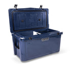 Left side 45 degree view of open large 71 litre blue cooler box with side handle, 2 easy lock latches on lid and bottle openers on each corner. Food divider / chopping board and wire food basket inside.