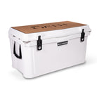 Left side 45 degree view of closed large 71 litre white cooler box with side handle, 2 easy lock latches on front and bottle openers on each corner.  Tan foam mat on lid with fish catch ruler.