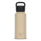 Front view of tan 960ml stainless steel drink bottle with closed lid and handle. Silver etched outdoor oath logo and sand dune icon on side.